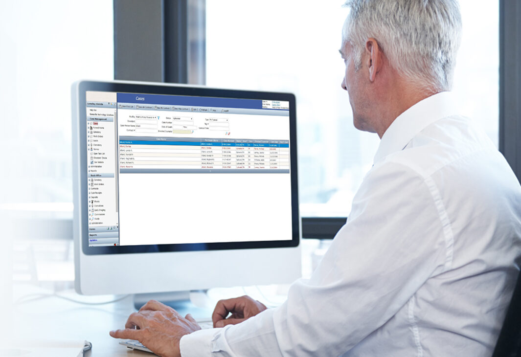 Male looking at business management program on computer