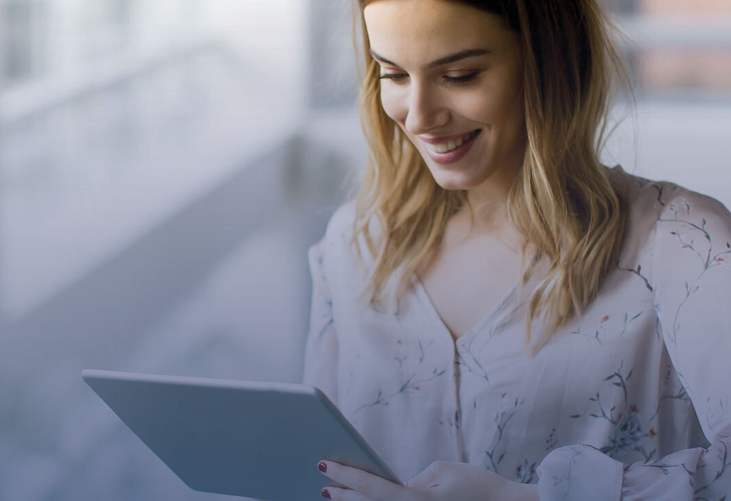 Women on tablet smiling